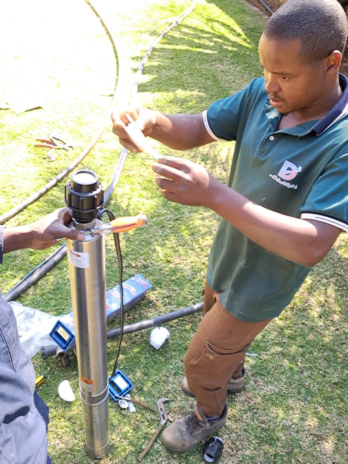 Lekker technician preparing a submersible borehole pump before installation